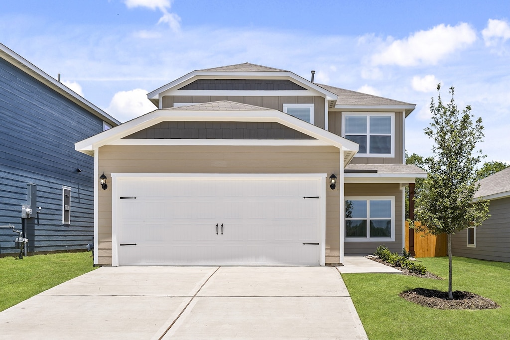 view of front of house with a garage and a front yard