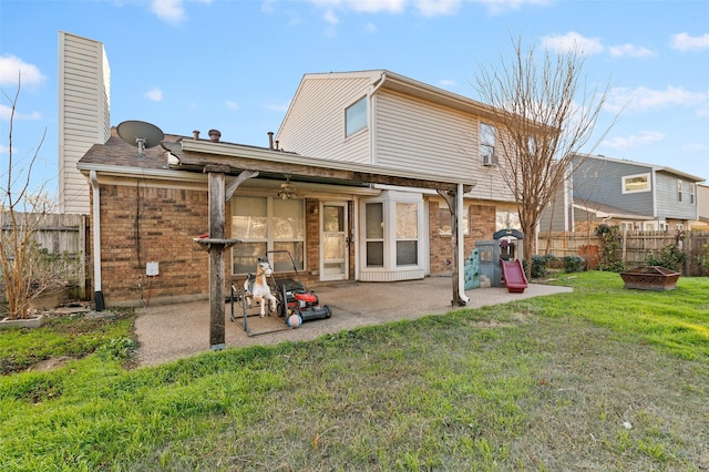 rear view of property featuring a yard and a patio area