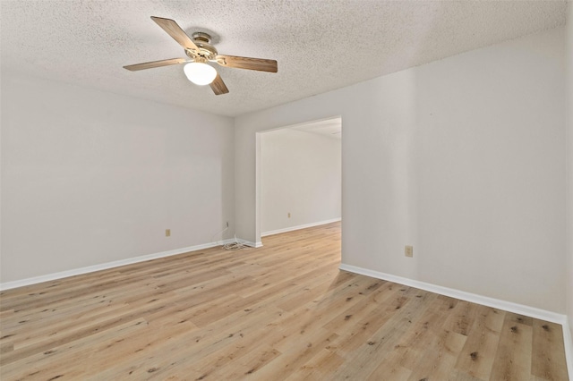 empty room featuring light wood-type flooring, a textured ceiling, and ceiling fan