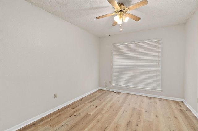 empty room with light wood-type flooring, a textured ceiling, and ceiling fan