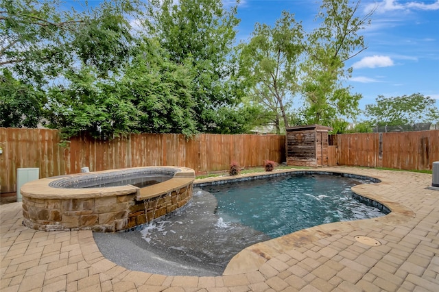 view of pool featuring an in ground hot tub and a patio area