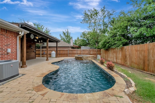 view of pool featuring a patio, central air condition unit, and an in ground hot tub