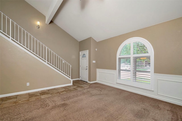 foyer with carpet and vaulted ceiling with beams