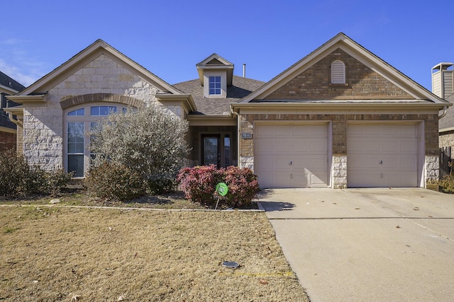 view of front facade featuring stone siding, concrete driveway, roof with shingles, and an attached garage