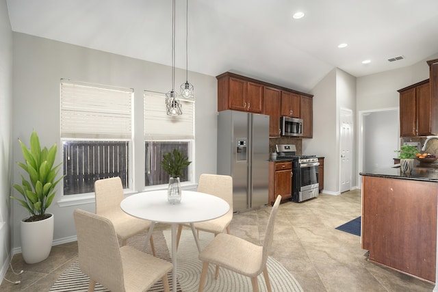 kitchen featuring stainless steel appliances, tasteful backsplash, dark countertops, and visible vents