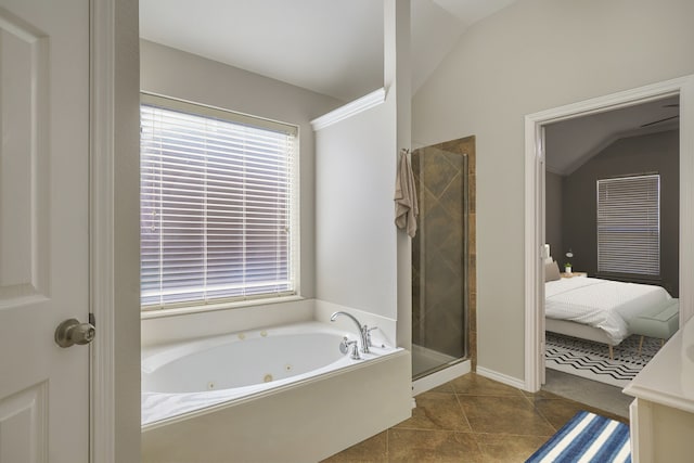 ensuite bathroom featuring a wealth of natural light, a shower stall, a whirlpool tub, and tile patterned floors