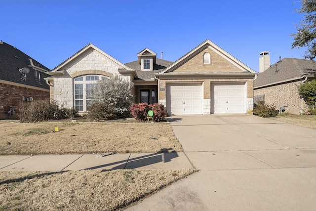 view of front of house with a garage, concrete driveway, a shingled roof, and stone siding