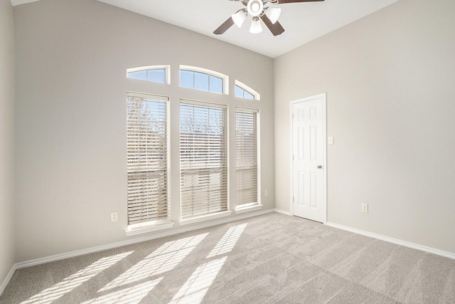 unfurnished room featuring ceiling fan, baseboards, and light colored carpet