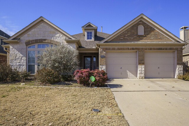 view of front of house with a garage, concrete driveway, roof with shingles, and stone siding