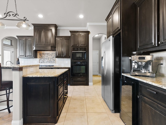 kitchen featuring a kitchen island, appliances with stainless steel finishes, beverage cooler, custom exhaust hood, and dark brown cabinetry