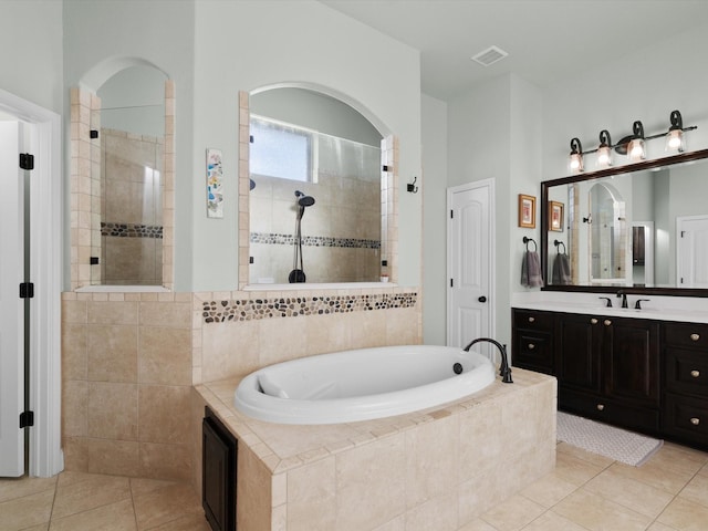 bathroom with independent shower and bath, vanity, and tile patterned flooring