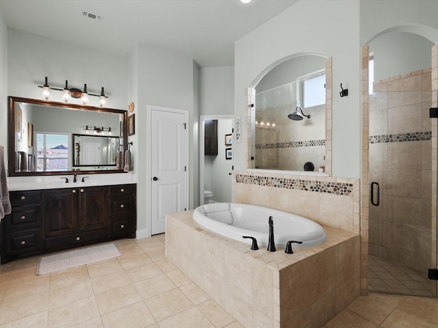 bathroom with vanity, tile patterned floors, independent shower and bath, and a healthy amount of sunlight