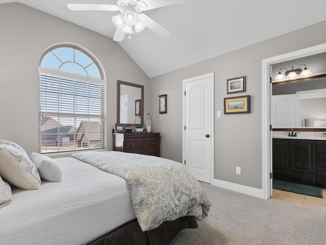 carpeted bedroom with multiple windows, sink, lofted ceiling, and ceiling fan