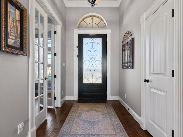 entryway with crown molding and dark wood-type flooring