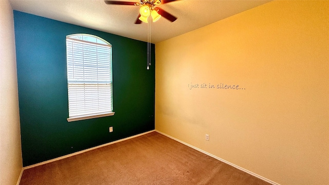 spare room featuring ceiling fan and carpet flooring