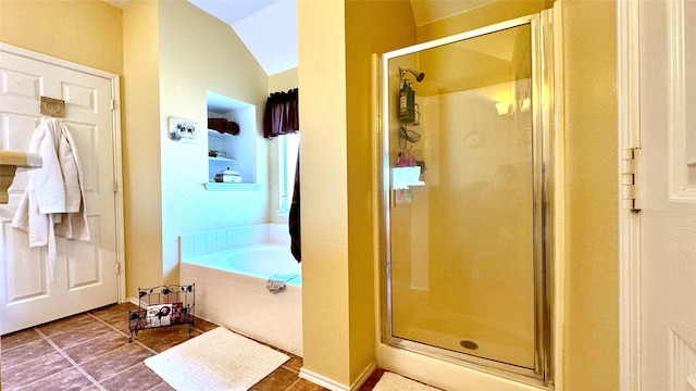 bathroom featuring tile patterned flooring, vaulted ceiling, and plus walk in shower