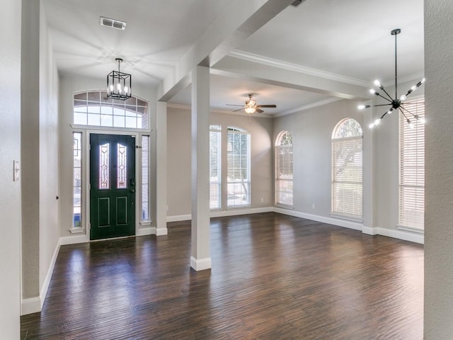 foyer with a wealth of natural light, dark hardwood / wood-style floors, and ornamental molding