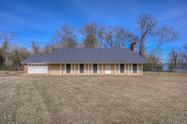 single story home featuring a garage, a front yard, and a porch