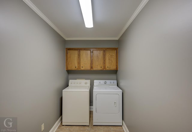 laundry area with washer and clothes dryer, ornamental molding, cabinets, and light tile patterned flooring