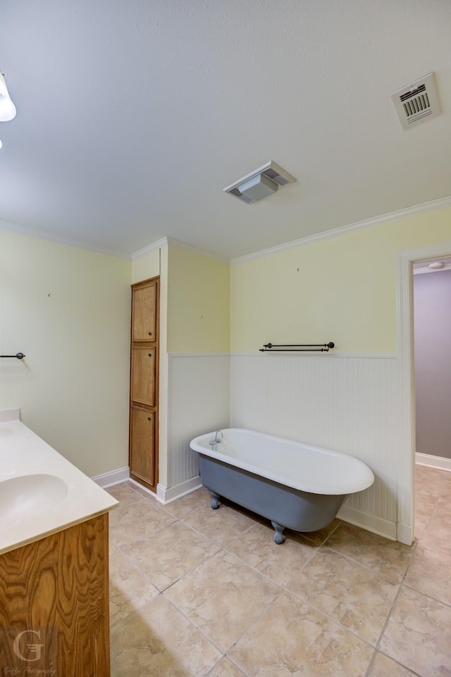 bathroom featuring a washtub, vanity, and crown molding