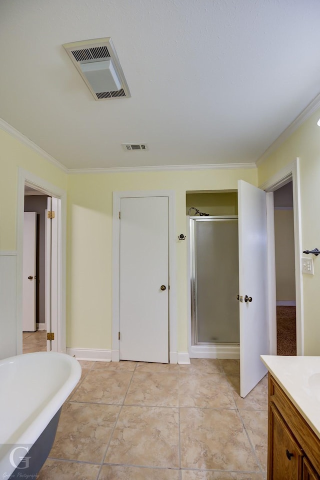 bathroom with ornamental molding, vanity, and shower with separate bathtub