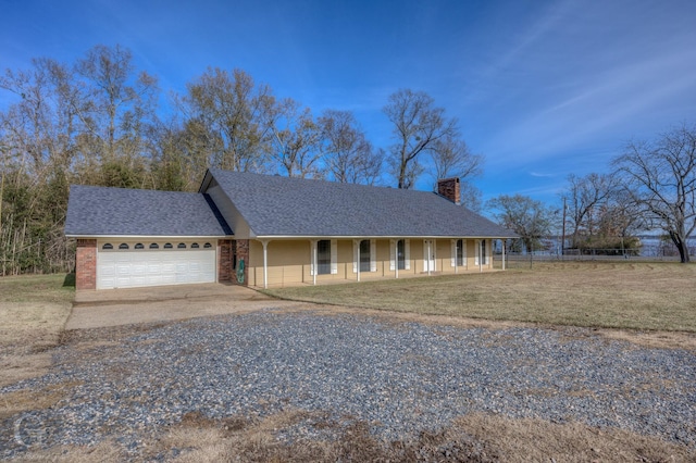 ranch-style house featuring a front yard, a porch, and a garage