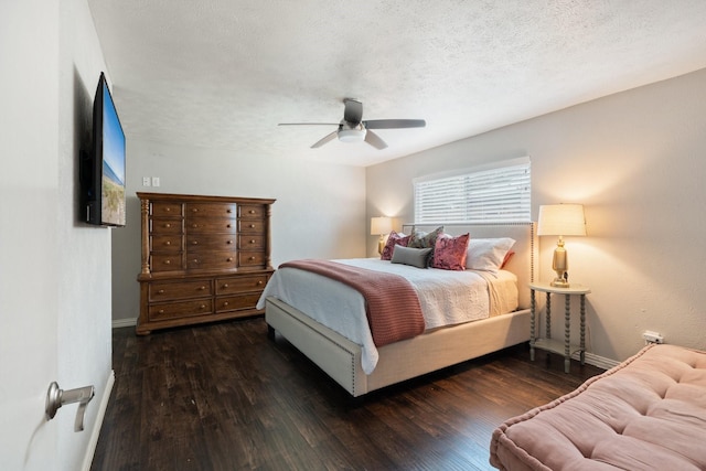 bedroom featuring ceiling fan, dark wood-type flooring, and a textured ceiling