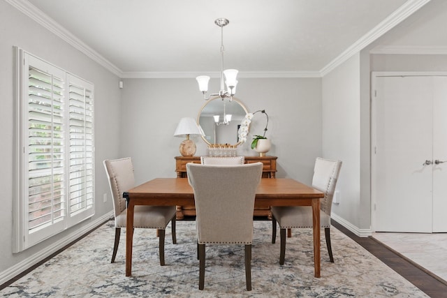 dining space featuring crown molding, an inviting chandelier, and wood-type flooring