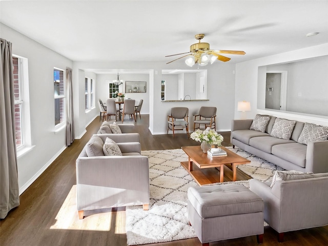 living room featuring ceiling fan and dark wood-type flooring