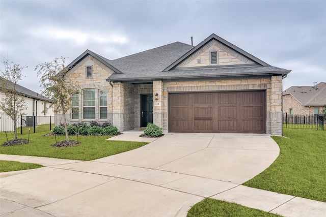 view of front of property with a garage and a front yard