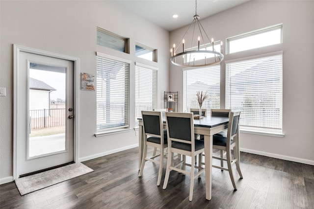 dining room with dark hardwood / wood-style floors and a chandelier