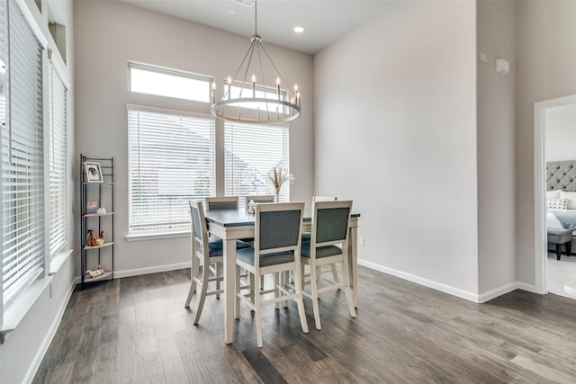 dining room featuring a notable chandelier and dark hardwood / wood-style floors