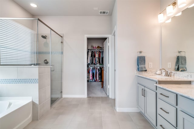 bathroom featuring vanity, shower with separate bathtub, and tile patterned floors