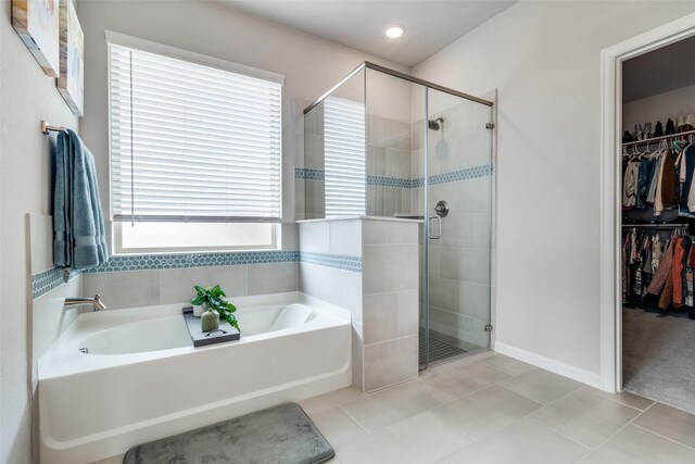 bathroom with separate shower and tub, a wealth of natural light, and tile patterned floors