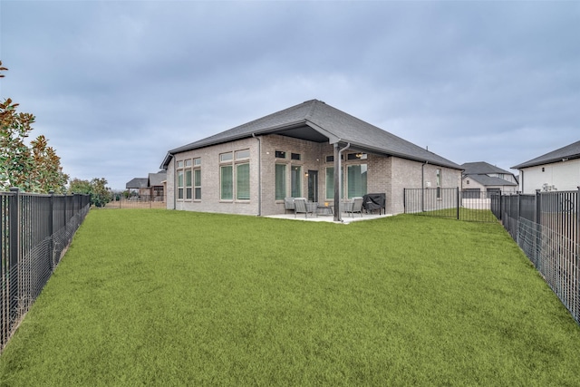 back of house featuring a yard and a patio area