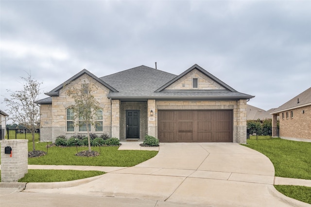 view of front of property with a garage and a front yard