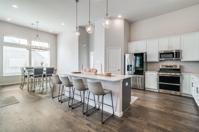 kitchen featuring white cabinetry, backsplash, pendant lighting, and stainless steel appliances