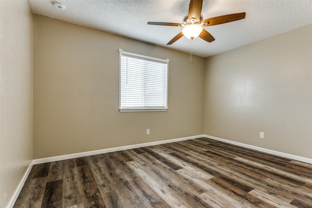 spare room with dark hardwood / wood-style flooring, ceiling fan, and a textured ceiling