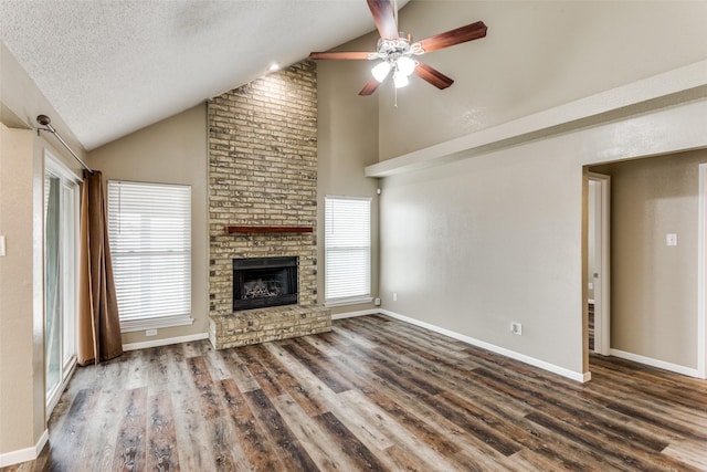 unfurnished living room with lofted ceiling, plenty of natural light, and a textured ceiling