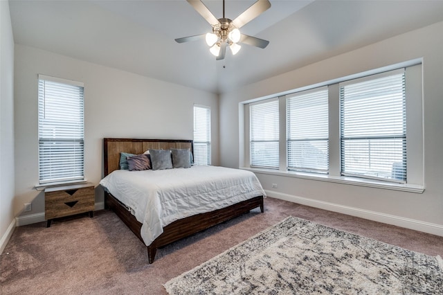 bedroom with ceiling fan, carpet flooring, and lofted ceiling