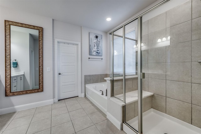 bathroom featuring independent shower and bath, vanity, and tile patterned flooring