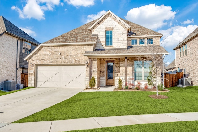 view of front of property with a porch, a garage, central air condition unit, and a front yard