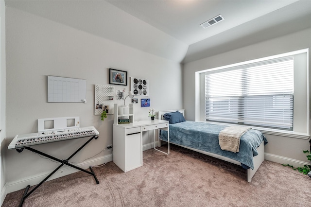 bedroom featuring vaulted ceiling and light colored carpet