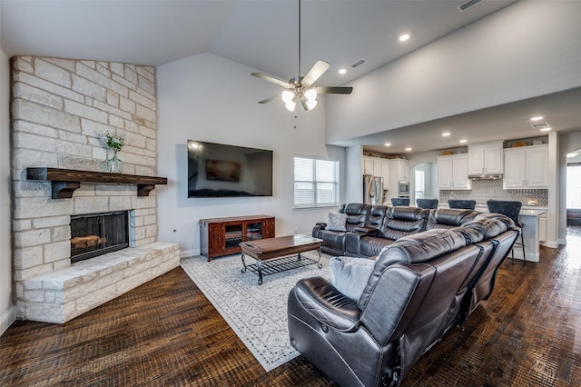 living room featuring ceiling fan, high vaulted ceiling, dark hardwood / wood-style floors, and a fireplace