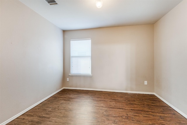 spare room with dark wood-type flooring