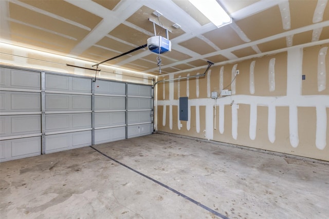 garage with a garage door opener and electric panel