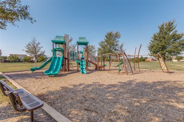 view of jungle gym featuring a lawn