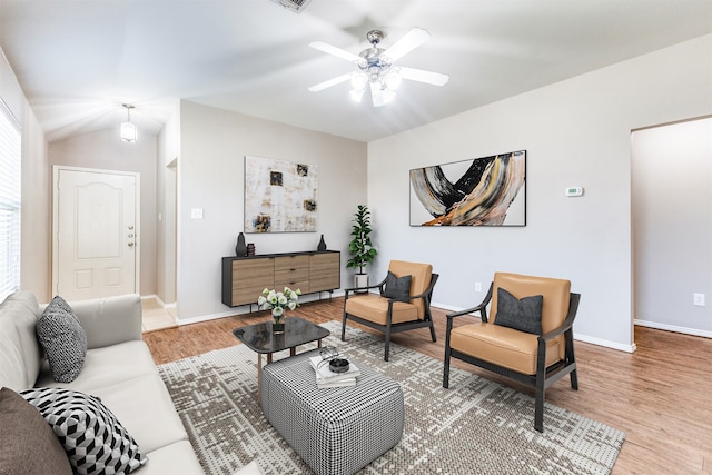 living room with vaulted ceiling, ceiling fan, and hardwood / wood-style floors