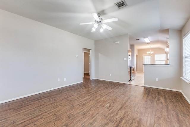 unfurnished room featuring ceiling fan with notable chandelier, hardwood / wood-style floors, and lofted ceiling