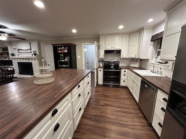 kitchen featuring butcher block counters, sink, black / electric stove, stainless steel dishwasher, and white cabinets